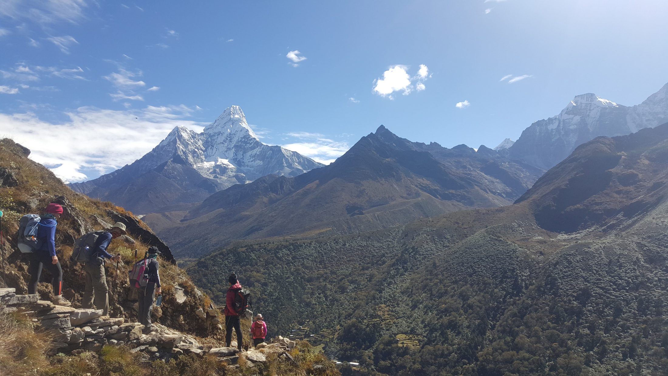 Mike Jones guiding a trek in the Himalayas, Ama Dablam visible behind
